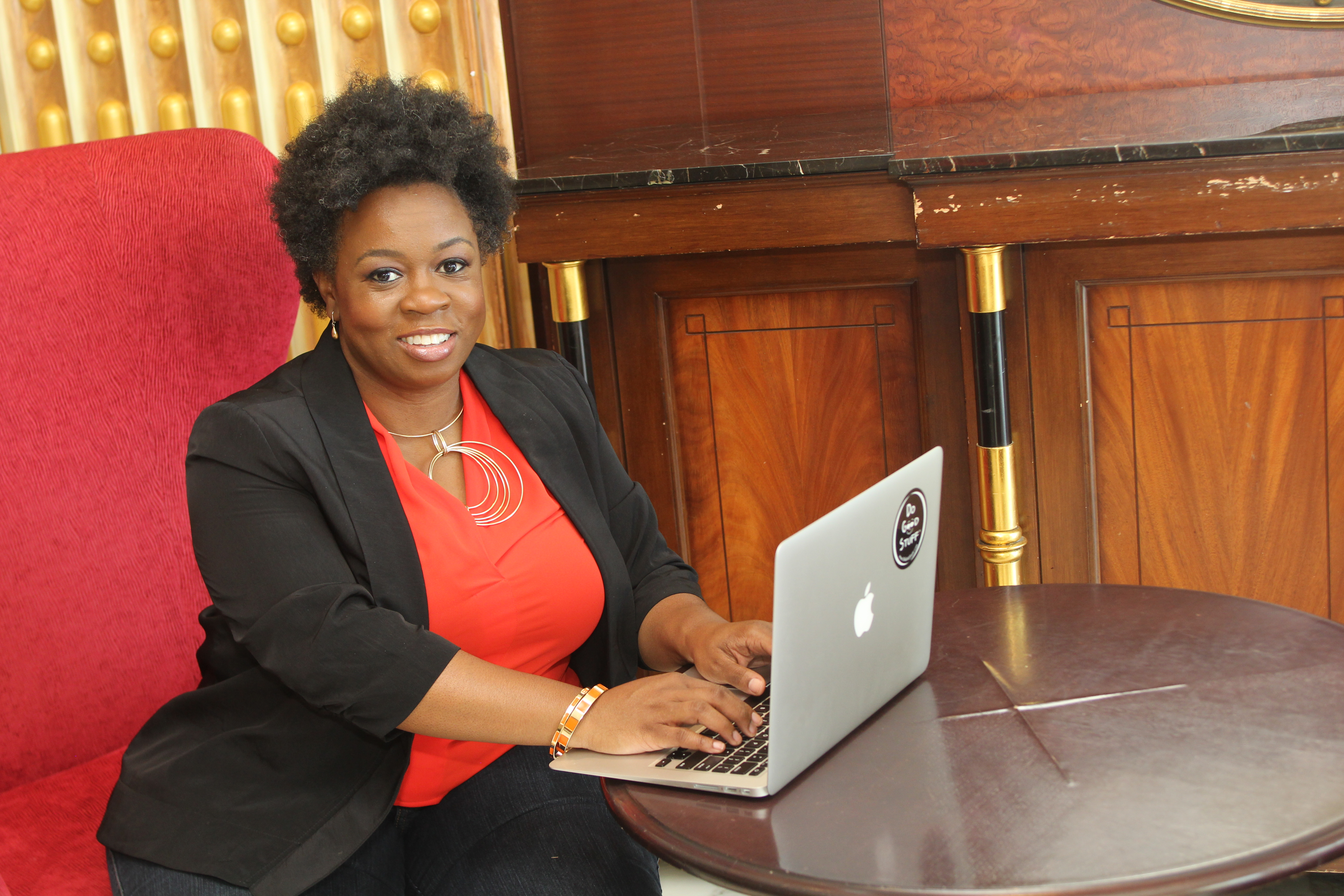 Michele Heyward, Founder PositiveHire sitting in front of a laptop
